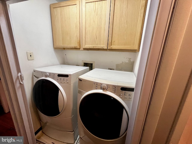 laundry room featuring cabinets and washer and dryer