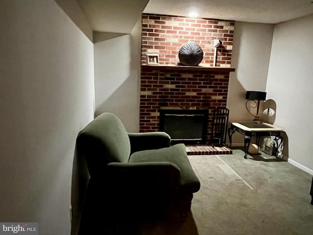 sitting room with carpet floors and a fireplace