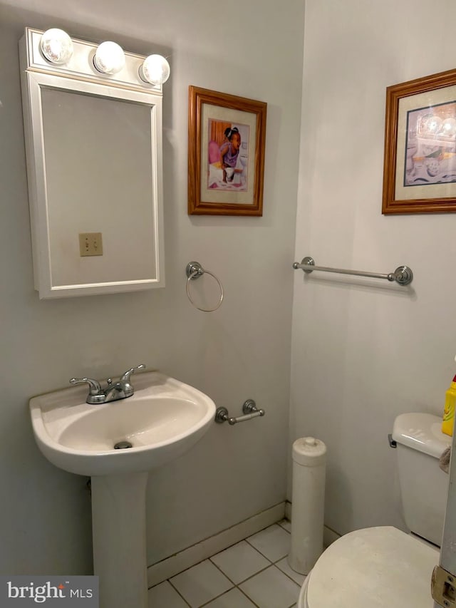 bathroom featuring toilet and tile patterned flooring