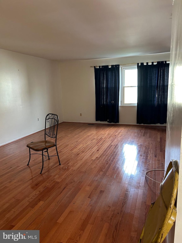 unfurnished room with hardwood / wood-style flooring