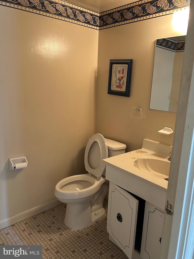 bathroom with vanity, toilet, and tile patterned flooring