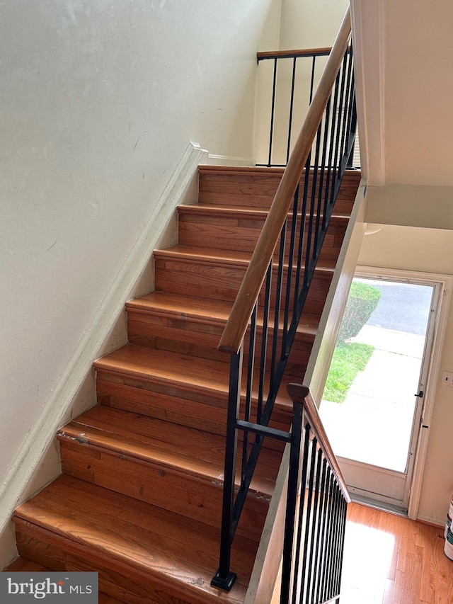 staircase featuring hardwood / wood-style flooring