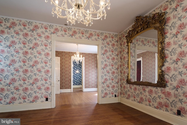 unfurnished dining area with ornamental molding, a chandelier, and dark hardwood / wood-style floors