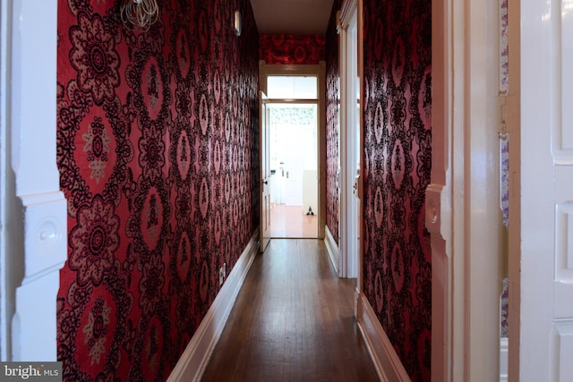 hallway with dark hardwood / wood-style flooring