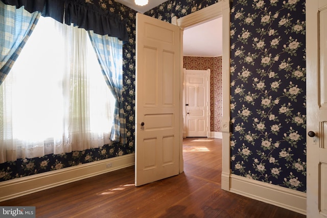 130 E Linn St, Bellefonte, PA 16823 - unfurnished room with baseboards, dark wood-style floors, plenty of natural light, and wallpapered walls
