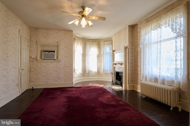 bedroom with radiator heating unit, ceiling fan, and dark hardwood / wood-style floors