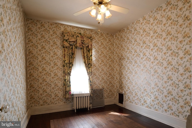 130 E Linn St, Bellefonte, PA 16823 - spare room with dark wood-style flooring, baseboards, wallpapered walls, a ceiling fan, and radiator