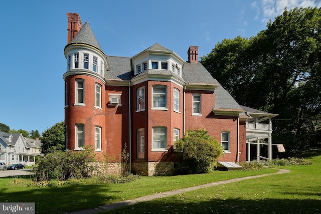 130 E Linn St, Bellefonte, PA 16823 - view of front of house with brick siding, a balcony, a chimney, and a front lawn