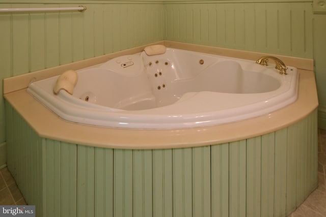 bathroom with a bathing tub and tile patterned floors