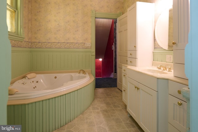 bathroom featuring vanity, tile patterned floors, and a tub