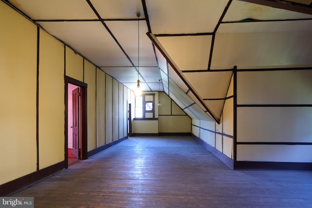 bonus room with dark hardwood / wood-style floors