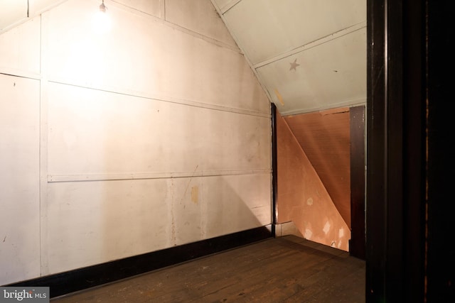 interior space featuring vaulted ceiling and dark hardwood / wood-style floors