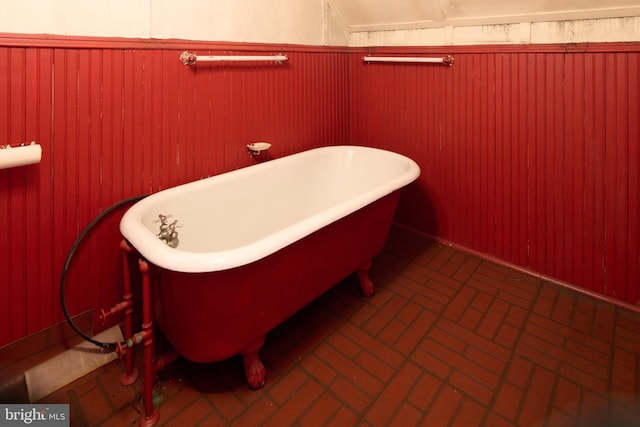 bathroom with wooden walls and a bathing tub