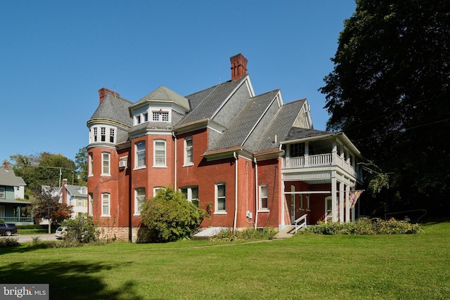 130 E Linn St, Bellefonte, PA 16823 - view of front facade featuring a chimney, a balcony, a front lawn, and brick siding