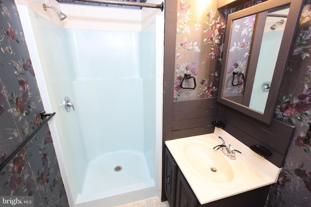 bathroom with vanity and a shower