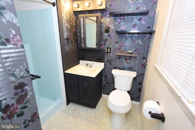 bathroom with vanity, a shower, tile patterned floors, and toilet