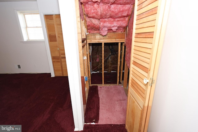 interior space featuring dark carpet and a fireplace