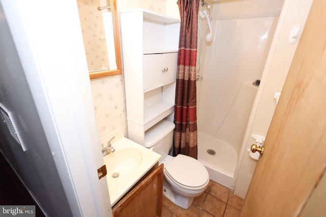 bathroom featuring tile patterned flooring, vanity, curtained shower, and toilet