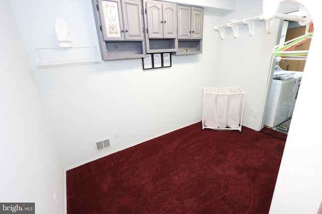 interior space featuring dark carpet and washer / dryer