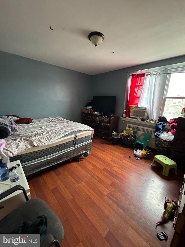 bedroom with wood-type flooring