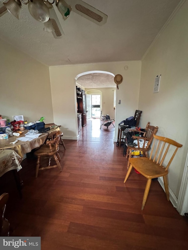 interior space featuring ceiling fan, a textured ceiling, crown molding, and hardwood / wood-style floors