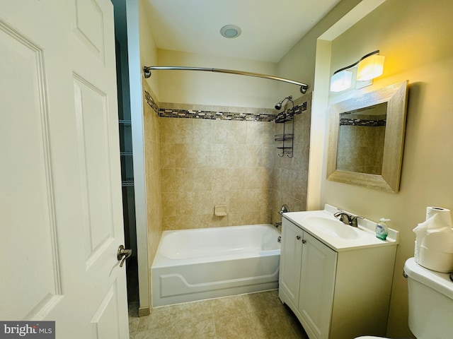 full bathroom featuring vanity, toilet, tile patterned flooring, and tiled shower / bath