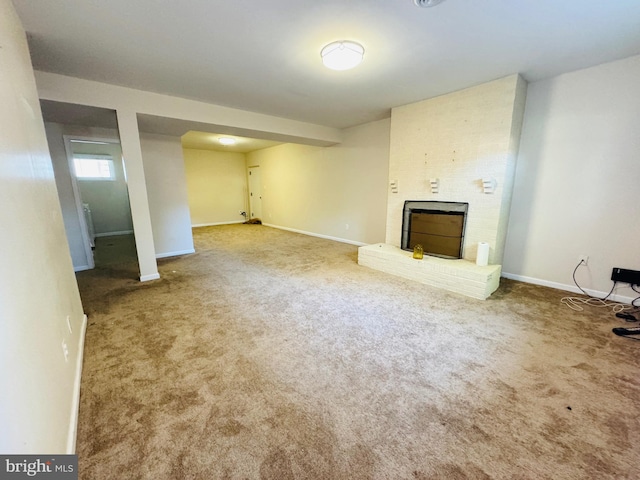 unfurnished living room with carpet flooring and a brick fireplace