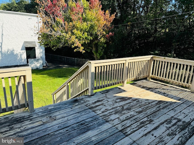 wooden terrace featuring a yard