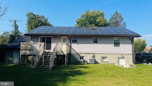 back of property featuring a yard, a wooden deck, and central AC unit