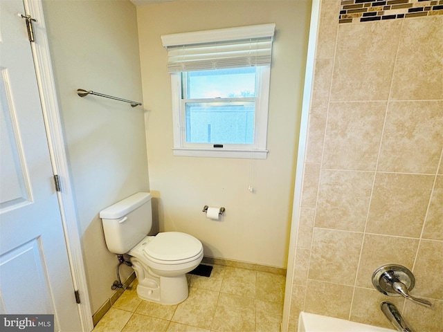 full bath featuring bathing tub / shower combination, toilet, tile patterned floors, and baseboards
