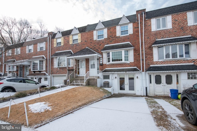 townhome / multi-family property featuring central AC unit and french doors