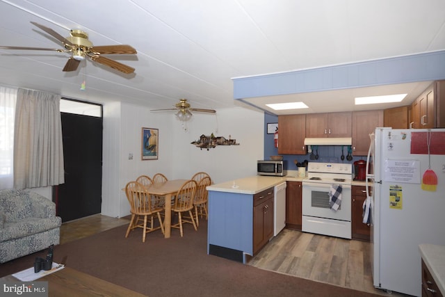 kitchen featuring wood-type flooring, white appliances, and ceiling fan