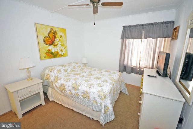 bedroom featuring ceiling fan, ornamental molding, and carpet flooring