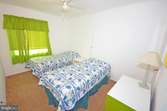 bedroom with ceiling fan, carpet floors, and crown molding