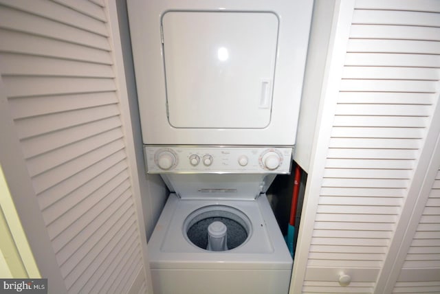 laundry room featuring stacked washer / drying machine