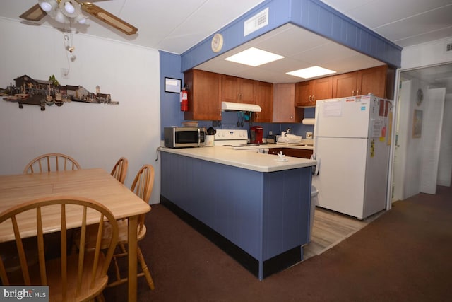 kitchen with crown molding, white appliances, light hardwood / wood-style flooring, and kitchen peninsula