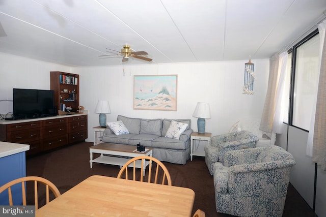 living room with wood walls and ceiling fan