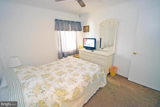 carpeted bedroom featuring ornamental molding and ceiling fan