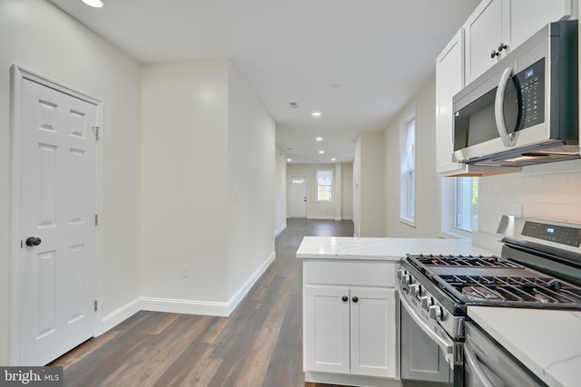 kitchen with white cabinetry, stainless steel appliances, and plenty of natural light