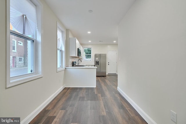 hallway with sink and dark wood-type flooring