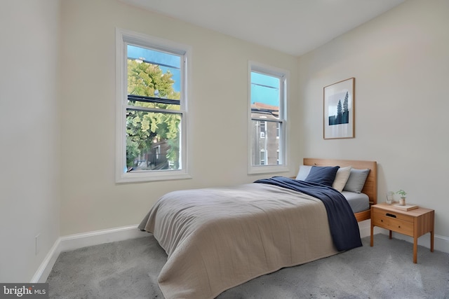 carpeted bedroom featuring multiple windows