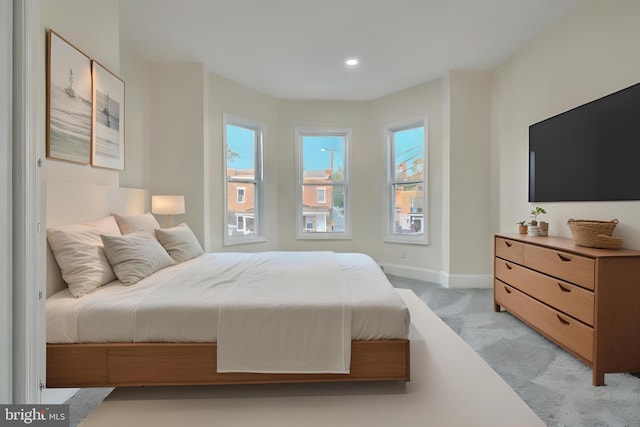 carpeted bedroom with multiple windows