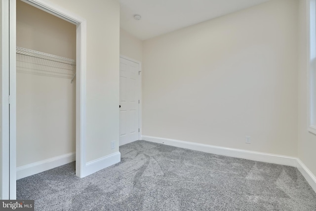 unfurnished bedroom with a closet and carpet