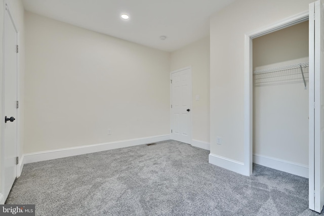 unfurnished bedroom featuring a closet and carpet