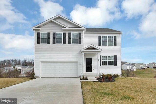 front facade featuring a garage and a front lawn