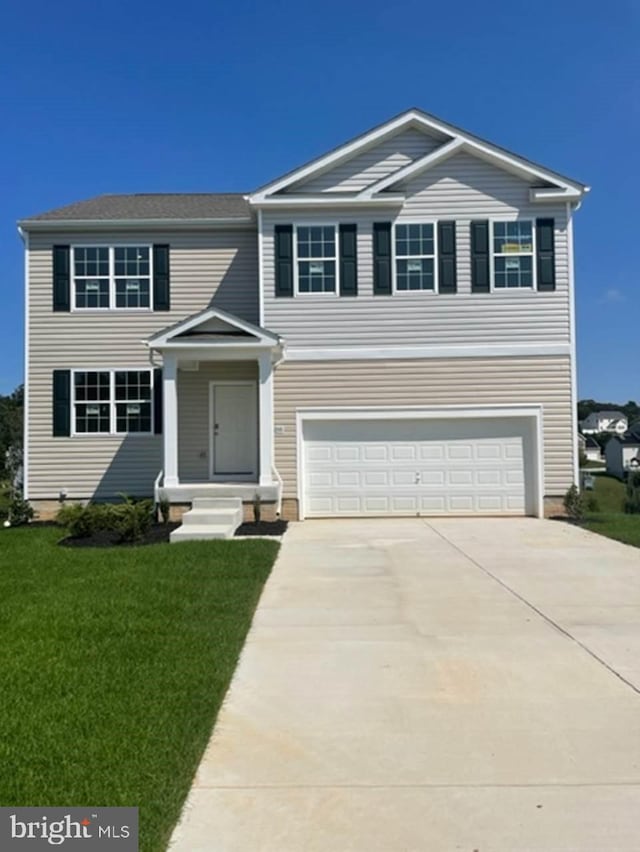 view of front facade featuring a front lawn and a garage