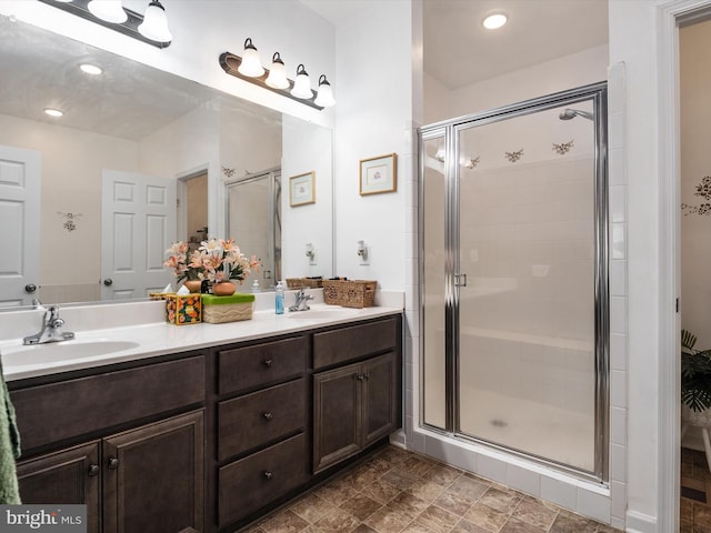 bathroom featuring vanity and a shower with shower door