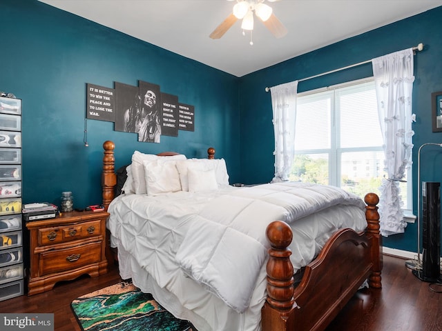 bedroom with dark hardwood / wood-style floors and ceiling fan