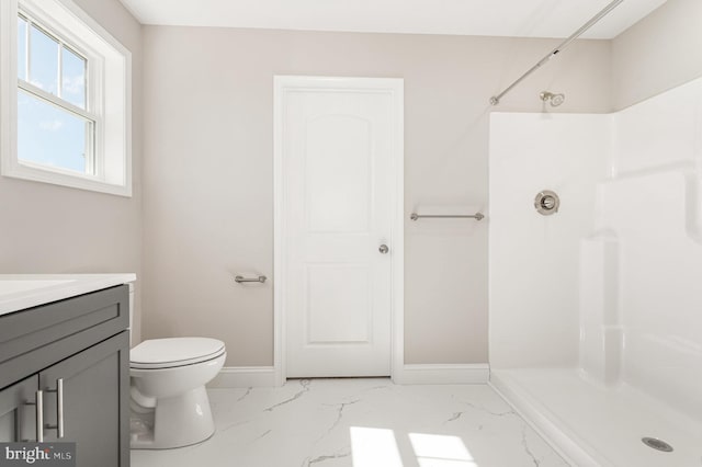 bathroom featuring vanity, toilet, and a shower