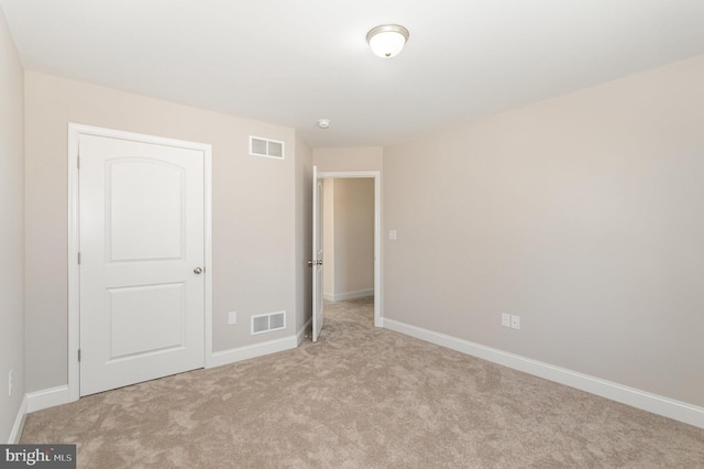 unfurnished bedroom with light carpet